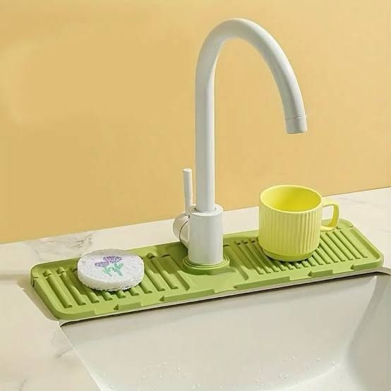 Silicone sink faucet mat splash guard wrapped around the base of a faucet, preventing water from splashing onto the countertop; foldable design for easy storage and kitchen organization in Lagos Nigeria