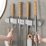 Wall-mounted Sulu mop holder with multiple slots and hooks for organizing mops, brooms, and cleaning tools; compact, space-saving design ideal for home or garage storage in Lagos Nigeria